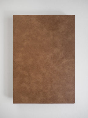 Rich, solid cognac brown notebook cover with a fine, subtle leather texture, ready for B5 grid journaling.