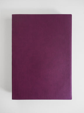 Solid, deep plum-colored notebook with a smooth, matte finish, featuring a simple, minimalist design suitable for journaling or study.