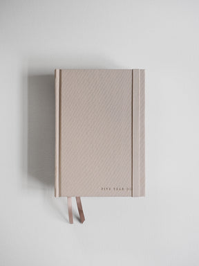 Elegant, pale blush hardcover diary featuring vertical embossed detailing and accented with two matching coordinating ribbons.