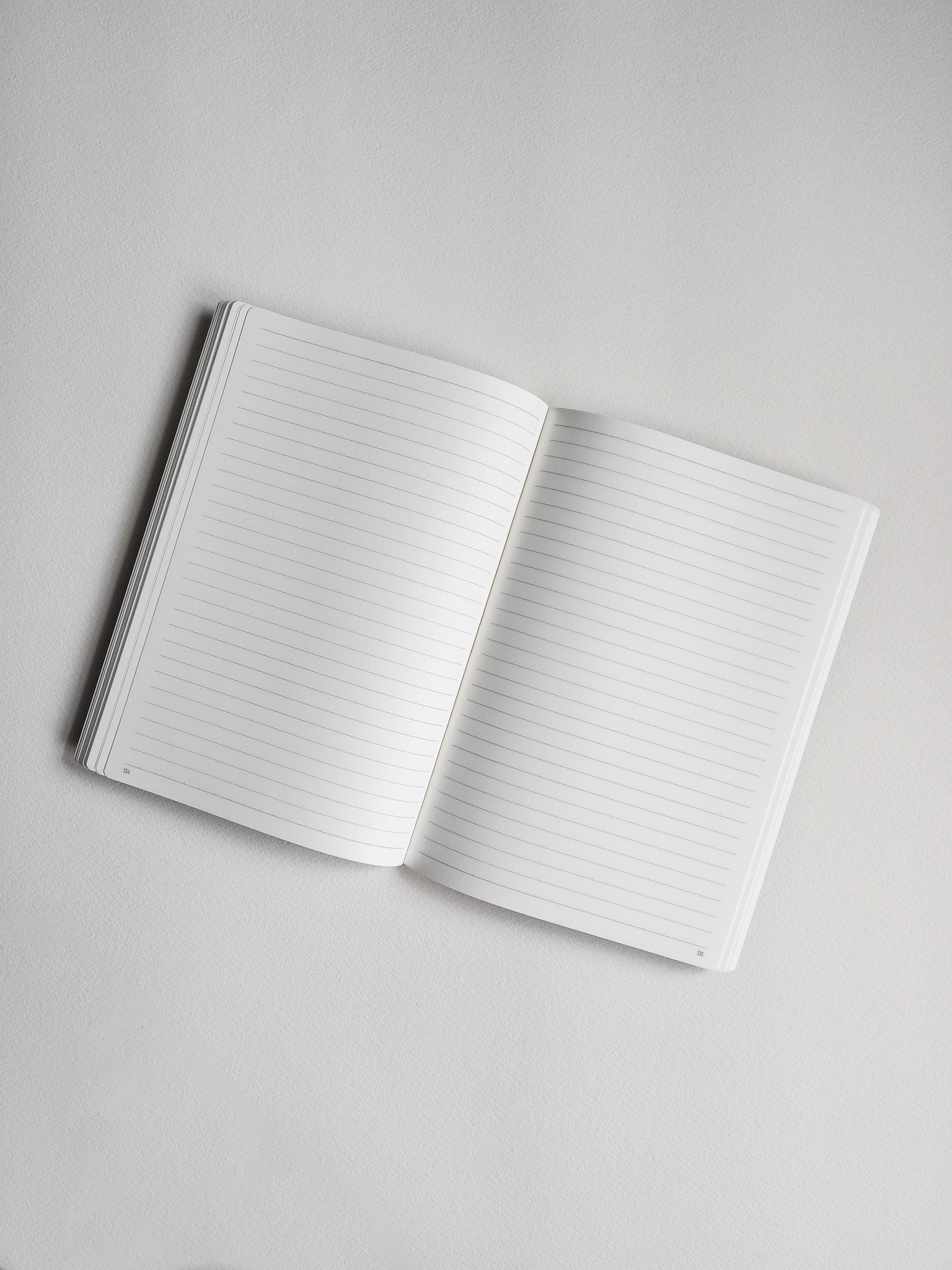 Open B6 notebook displaying crisp, lined white pages ready for writing notes, study material, or journaling.