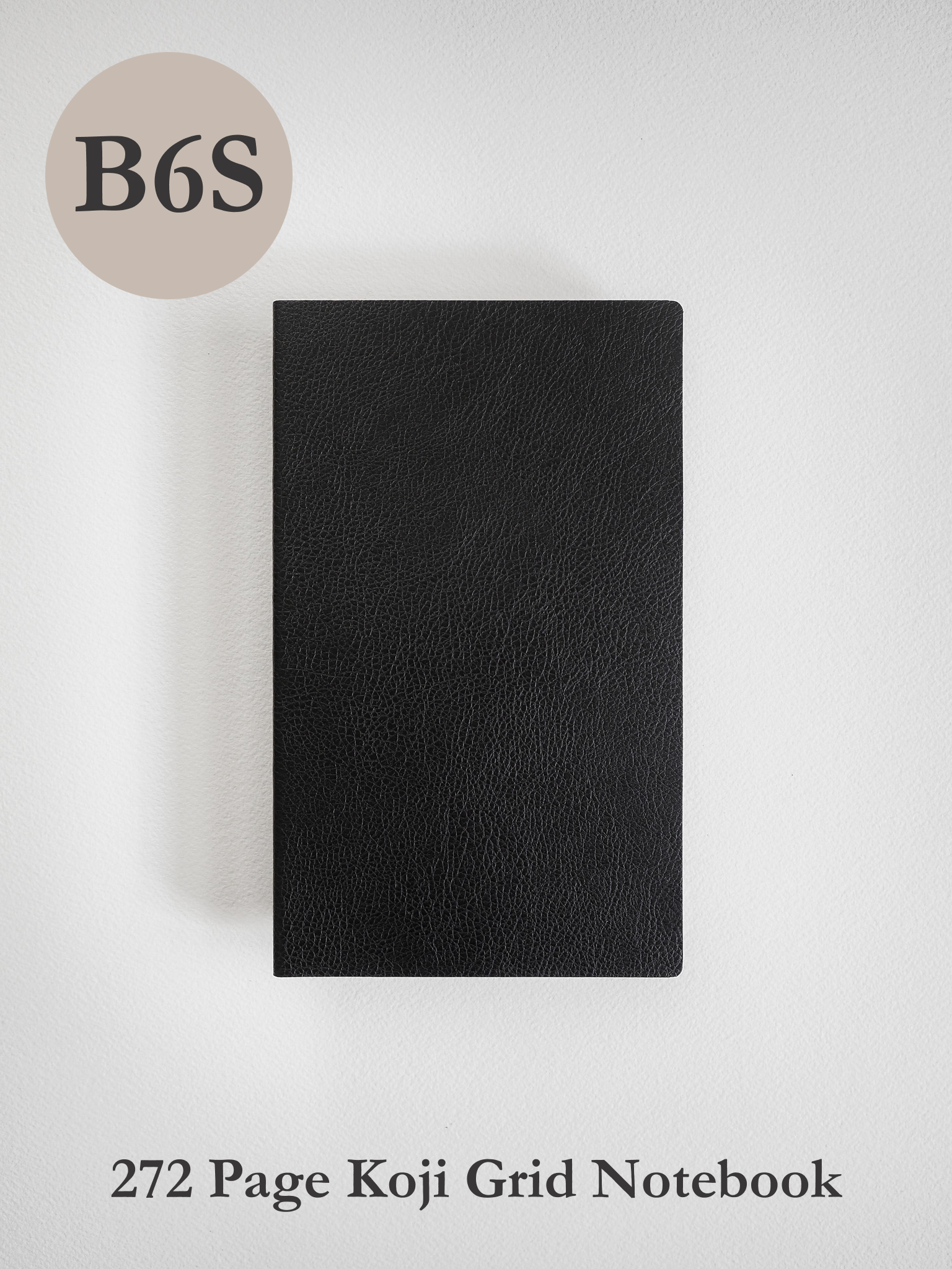 A sleek, solid black B6 grid notebook featuring a matte, minimalist cover, perfect for journaling and detailed academic notes.