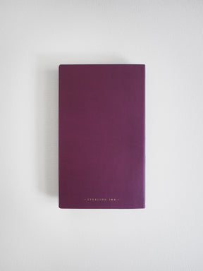 Deep plum-colored B6 slim grid notebook featuring the brand name "STERLING INK" subtly printed near the bottom center of the cover.