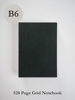 Solid black B6 notebook featuring a smooth, textured cover, designed for professional writing, sketching, and structured grid note-taking.
