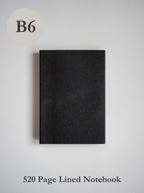 A deep black, textured B6 notebook featuring a sophisticated, unadorned cover suitable for journaling or note-taking.