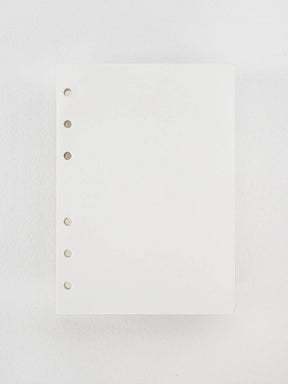Plain white loose leaf inserts of high-quality Tomoe River paper, featuring several finger-punched holes designed for ring binding.