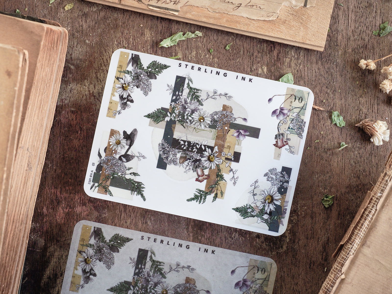Elegant botanical corner stickers featuring detailed clusters of white and dark florals, lush greenery, and antique silver foil accents for scrapbooking.