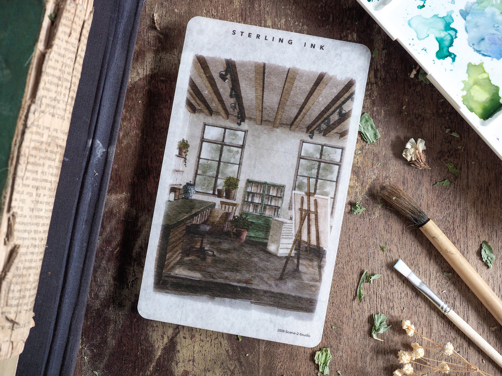 Illustrative sticker depicting a charming, rustic studio interior with large windows, exposed wooden beams, and a classic workspace.