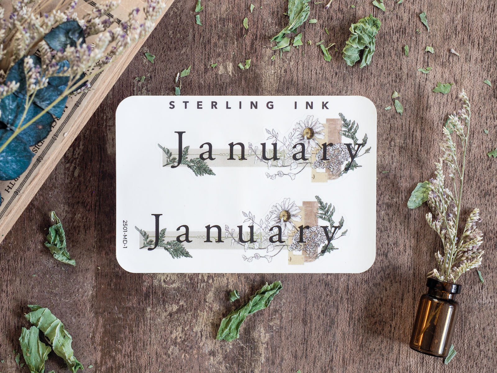 Elegant white month sticker for January, featuring the month name surrounded by a rustic botanical wreath of delicate ferns and pale floral illustrations.