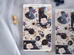Celestial floral sticker sheet featuring deep navy backgrounds, soft watercolor blossoms, pink accents, and gold foil moons.