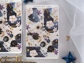 Celestial and botanical sticker strips featuring deep navy backgrounds, soft pink roses, purple flowers, and elegant gold constellations.