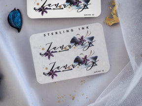 Elegant January month sticker featuring deep purple floral accents and sophisticated script lettering for journaling and planning.