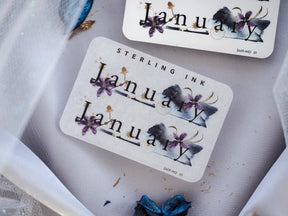 Elegant journaling sticker featuring "January" in a vintage font, surrounded by deep indigo watercolor flowers and washes.