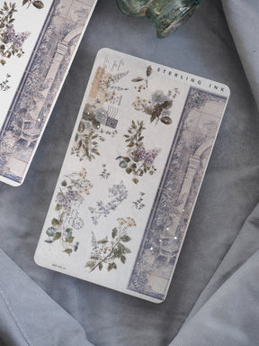 Elegant washi strip stickers featuring a vintage botanical pattern of deep green leaves and wildflowers mixed with subtle silver foil accents and architectural engravings.