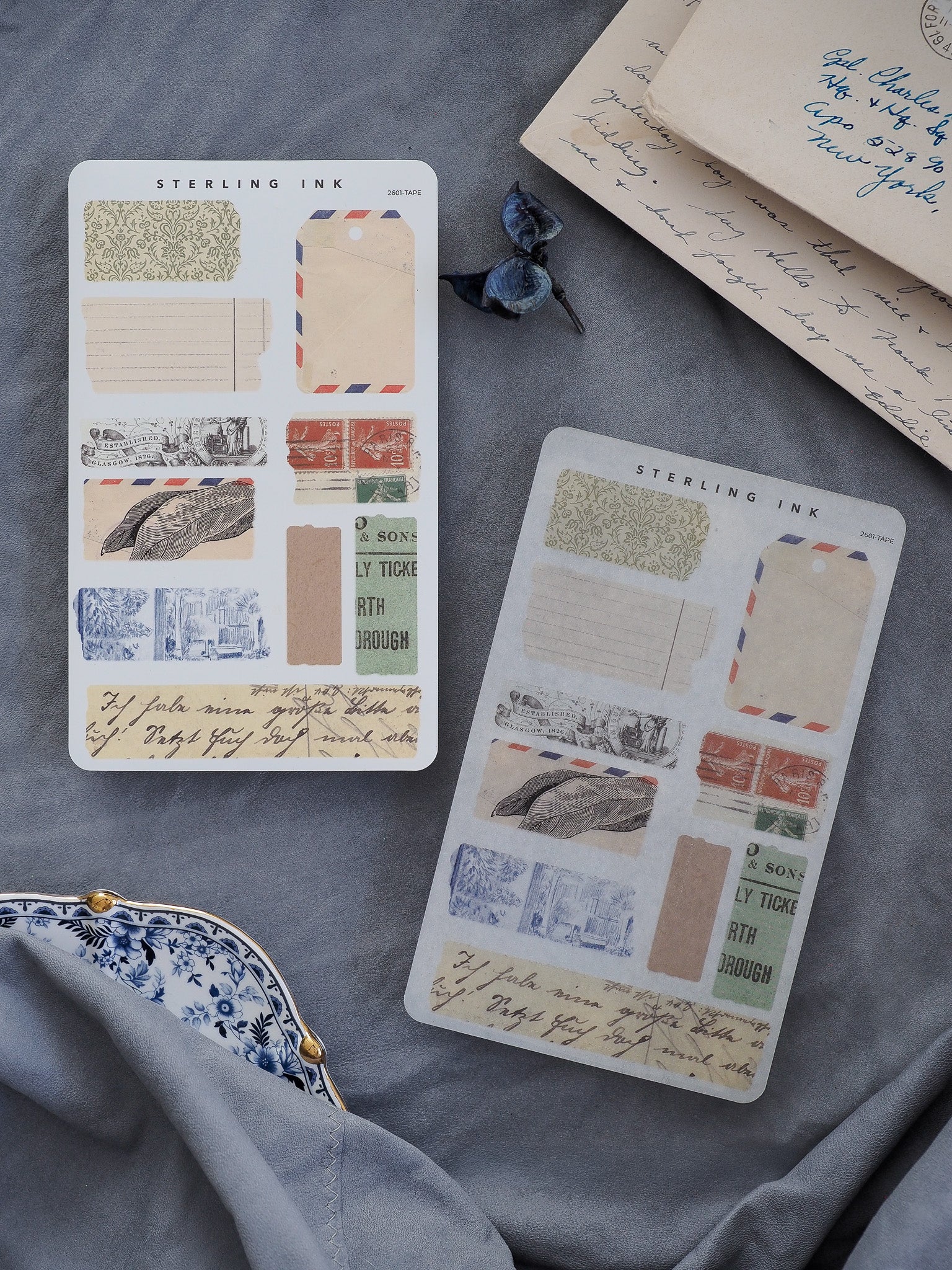 Archival sheet of torn tape stickers featuring distressed ink stamps, beige and blue ripped paper, and vintage typography for journaling and scrapbooking.