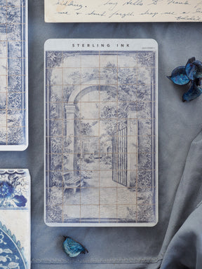 Vintage, monochromatic sticker featuring an arched garden entrance and wrought iron gate framed by lush, overgrown foliage and rendered in delicate blue-gray ink.