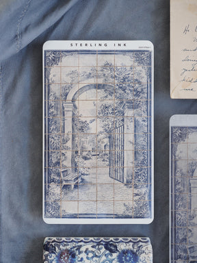 Antique blue and white printable strip stickers featuring a detailed European street scene with arches and tiled architectural patterns.