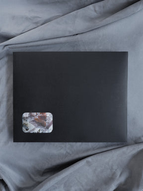 Minimalist black planner kit showcasing a nature-inspired corner accent of muted earth tones and botanical elements for journaling and organization.