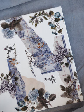 Elegant floral pattern notebook cover featuring watercolor blue and lilac bouquets mixed with antique tiled panels, titled 'Vellum - January 2026'.