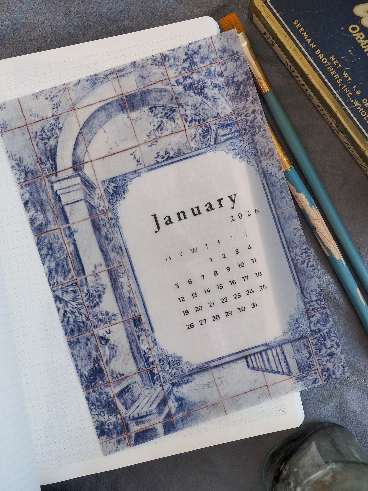 Elegant blue and white tiled calendar page for January 2026, framed by a distressed mosaic architectural border for planning.
