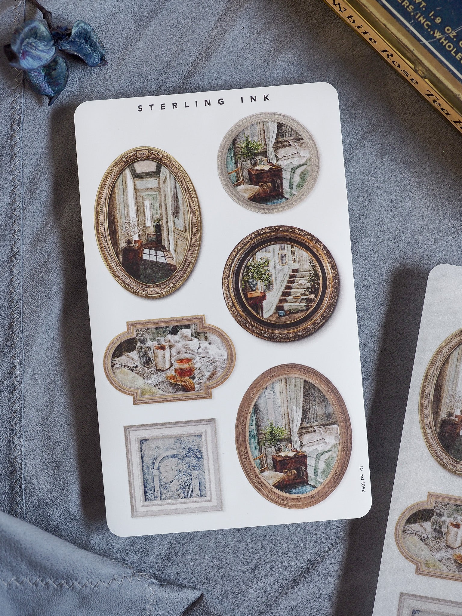 Decorative sticker sheet featuring various oval and rectangular vintage picture frames showcasing detailed sketches of architectural and interior scenes.