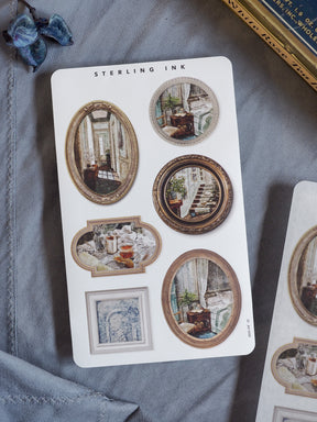 Decorative sticker sheet featuring various oval and rectangular vintage picture frames showcasing detailed sketches of architectural and interior scenes.