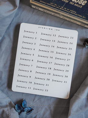 White calendar sticker sheet featuring a printed grid of numbered dates for January, providing an organized planning tool for 2026.