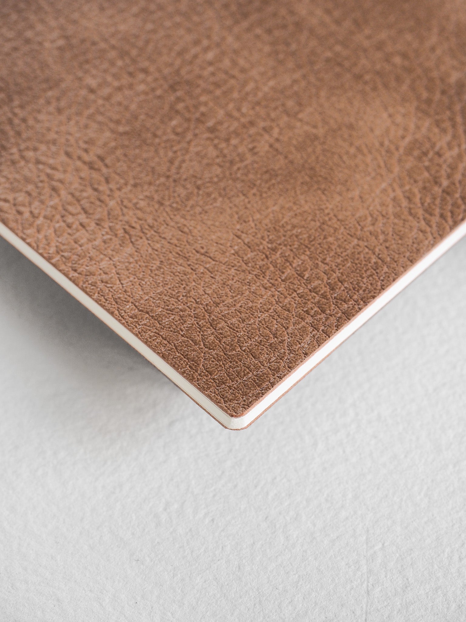 Textured cocoa brown B5 notebook booklet with a rich, faux leather cover, perfect for journaling and writing.