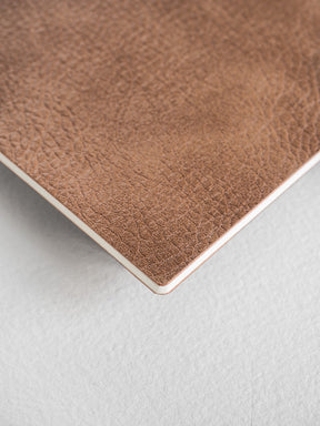 Textured cocoa brown B5 notebook booklet with a rich, faux leather cover, perfect for journaling and writing.
