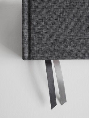 Dark gray textured A5 hardcover diary featuring a sophisticated woven fabric binding and two decorative satin ribbons.