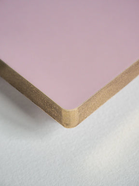 A close-up of a square pink board or panel with a natural wood edge, shown on a light gray textured surface.
#Color_Fairyfloss
