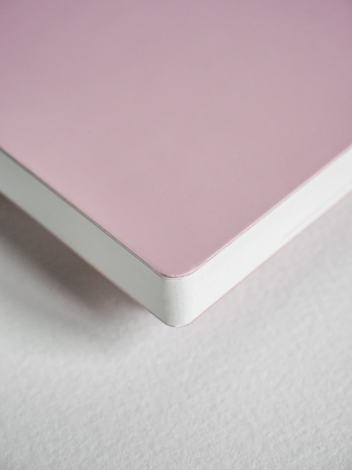 Close-up of a pink surface with a white edge on a light gray background
#Color_Fairyfloss