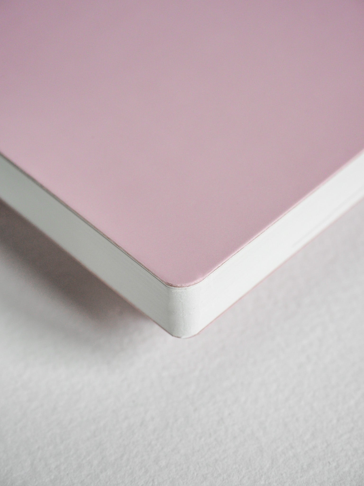 Minimalist blush pink horizontal planner with a solid cover, perfect for undated daily scheduling and year-long organization.