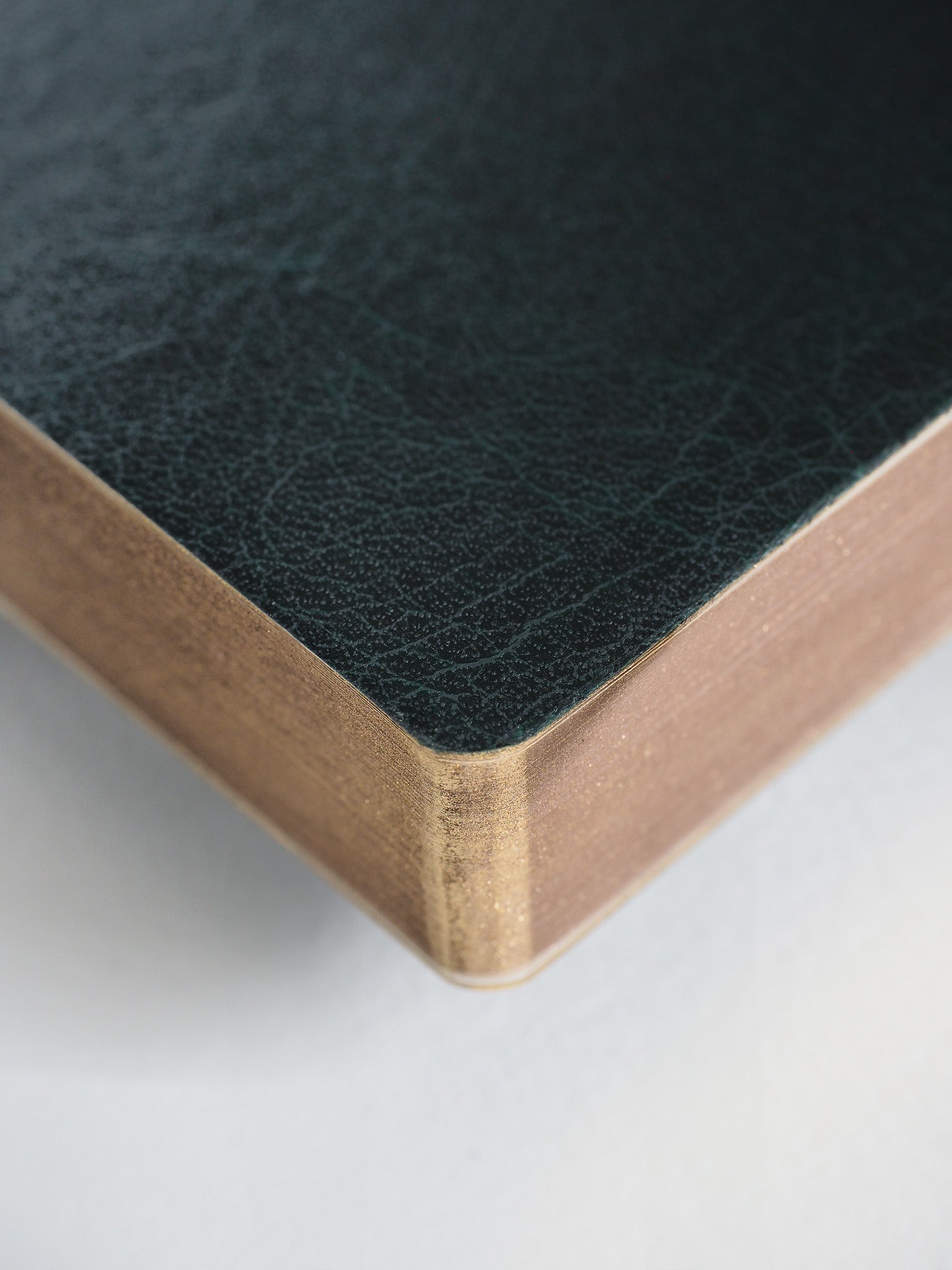 A B6 2026 planner featuring a dark, textured cover and sophisticated gold-edged construction for year-long planning.