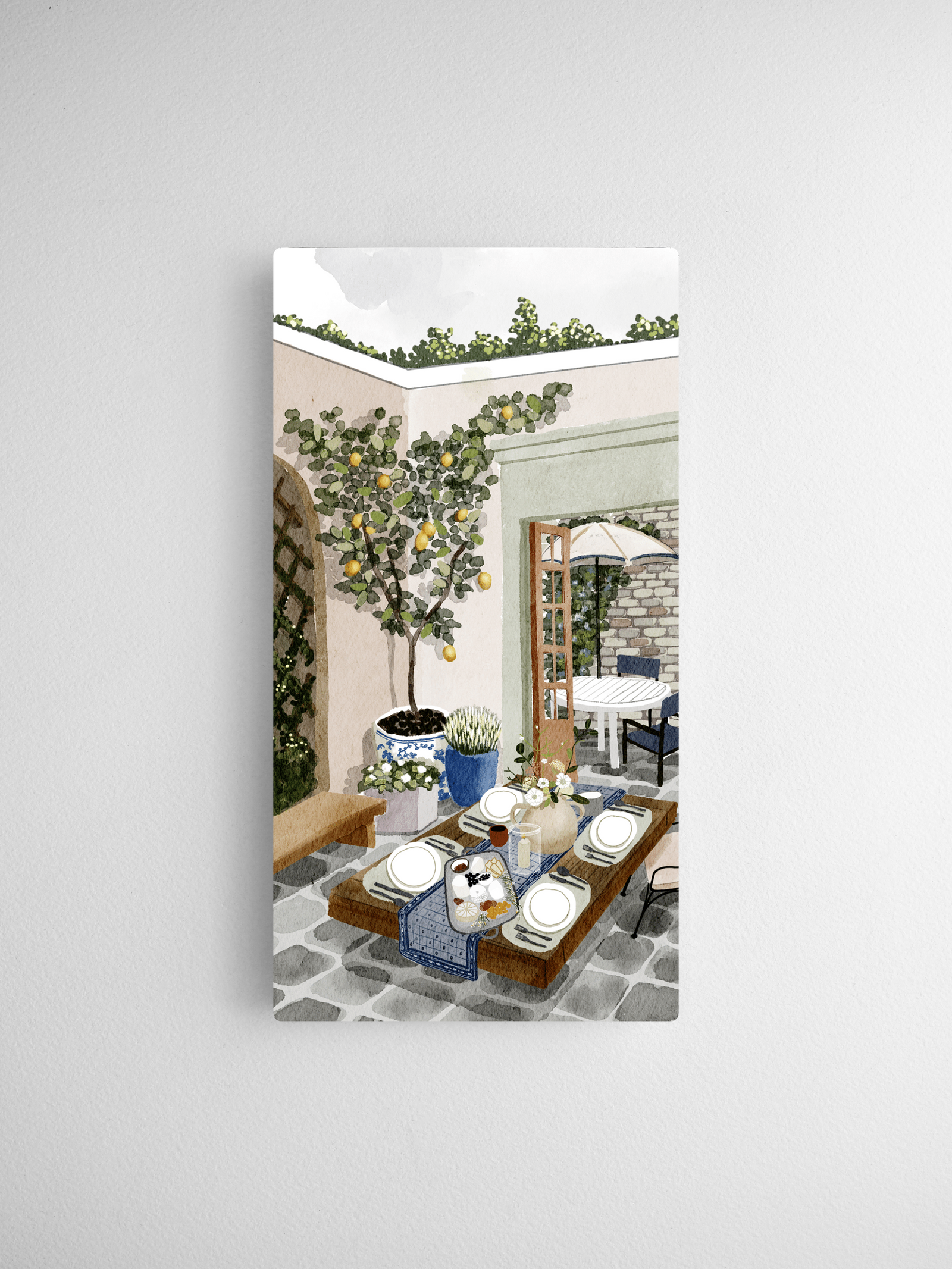 Watercolor illustration of a sunny Mediterranean cafe scene, featuring an olive tree, bistro table setting, and fresh pastries on a tiled patio.