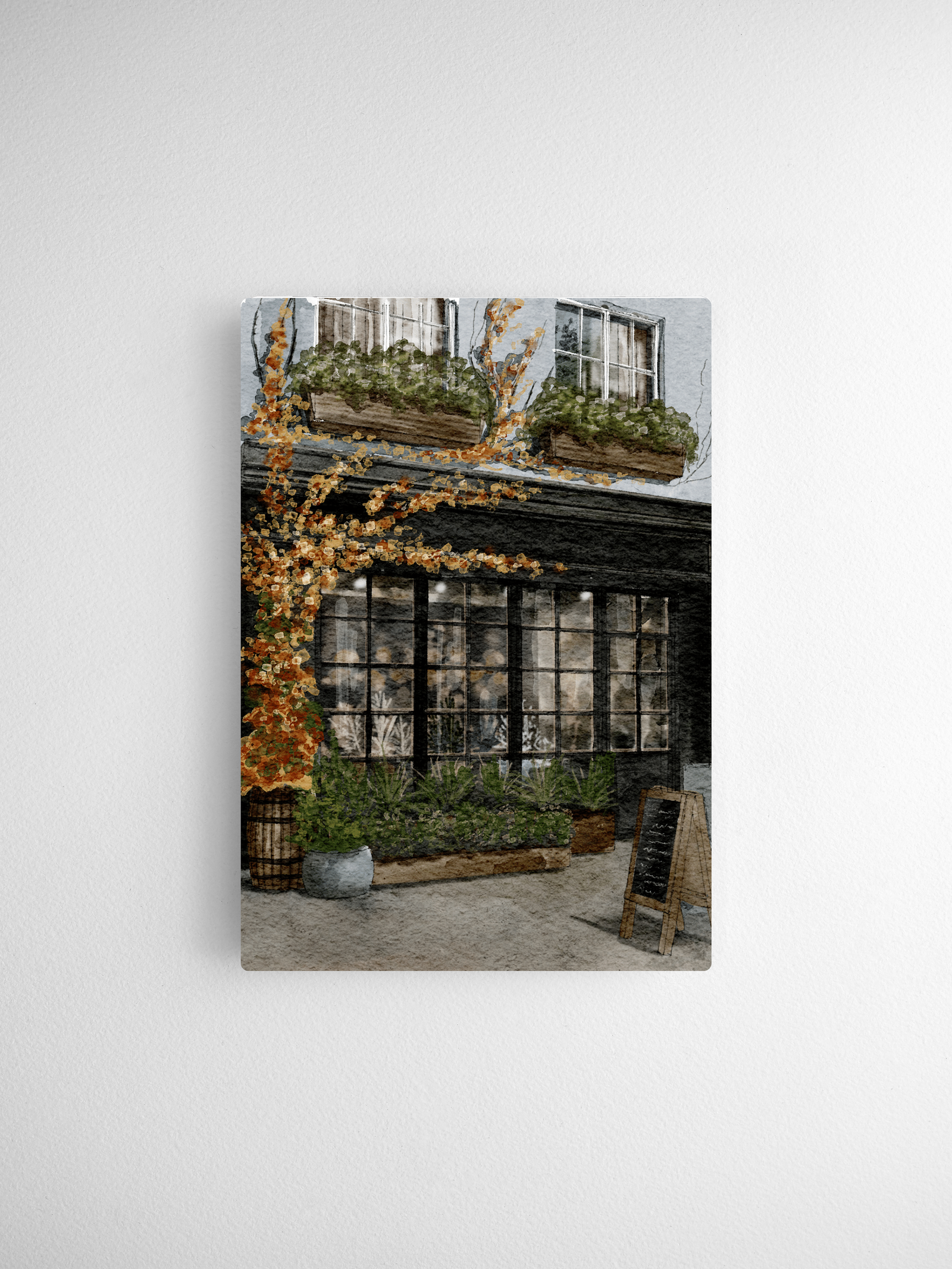 Autumn foliage illustration featuring bright yellow and orange leaves draped over a quaint storefront and potted greenery.