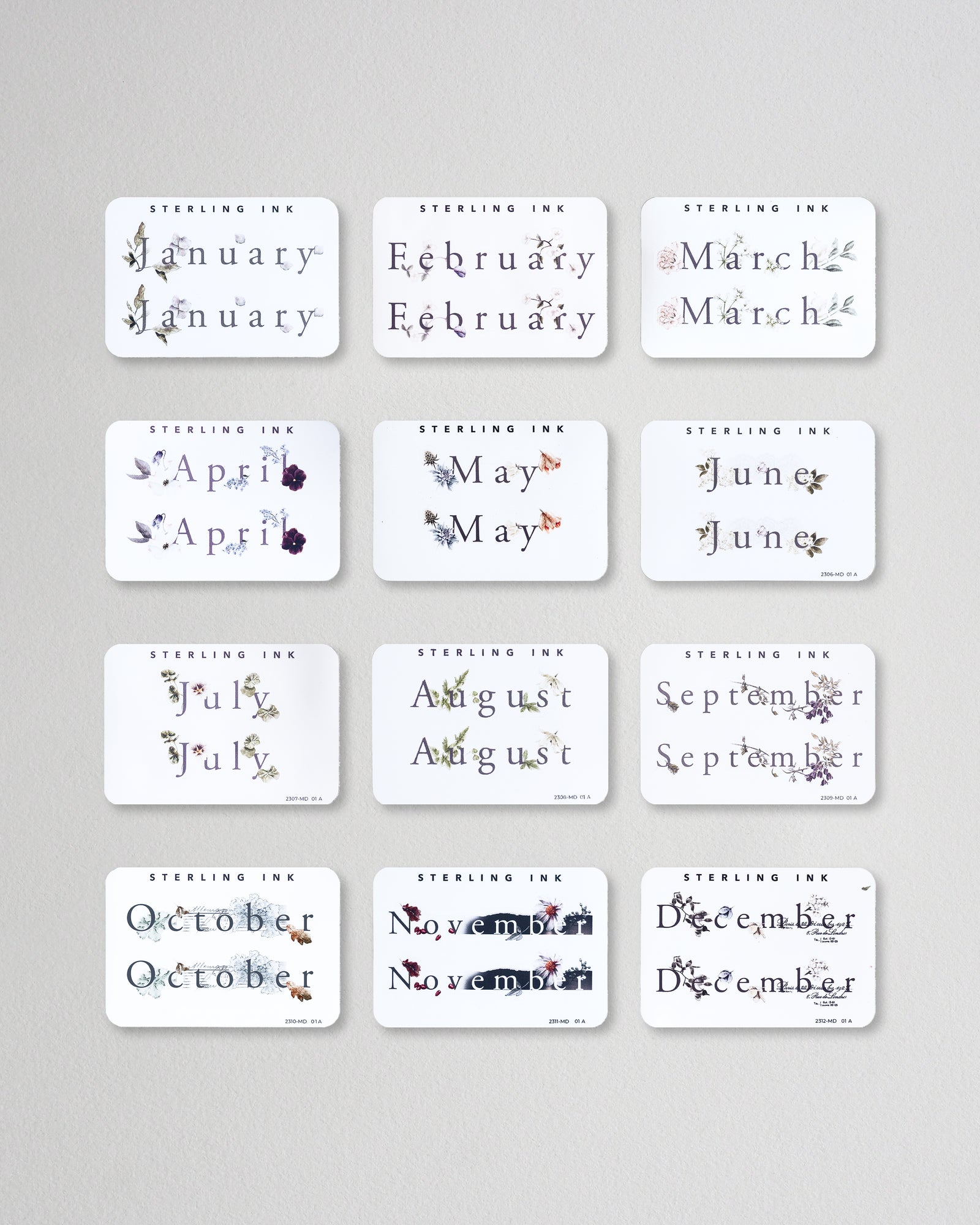 all 12 months of our Month Sticker from 2023 in the Print format. All 12 stickers are laid out in a grid format