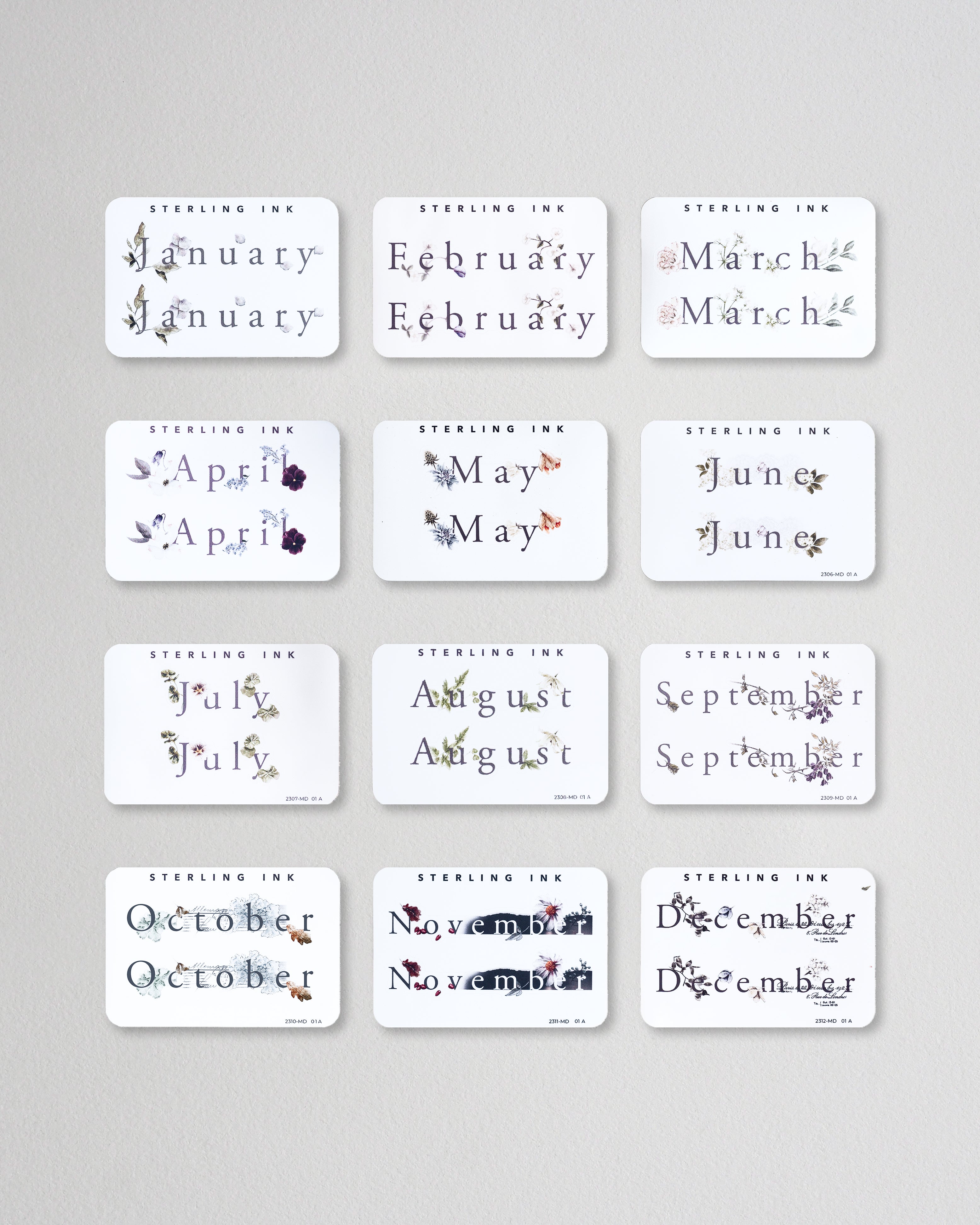 all 12 months of our Month Sticker from 2023 in the Print format. All 12 stickers are laid out in a grid format