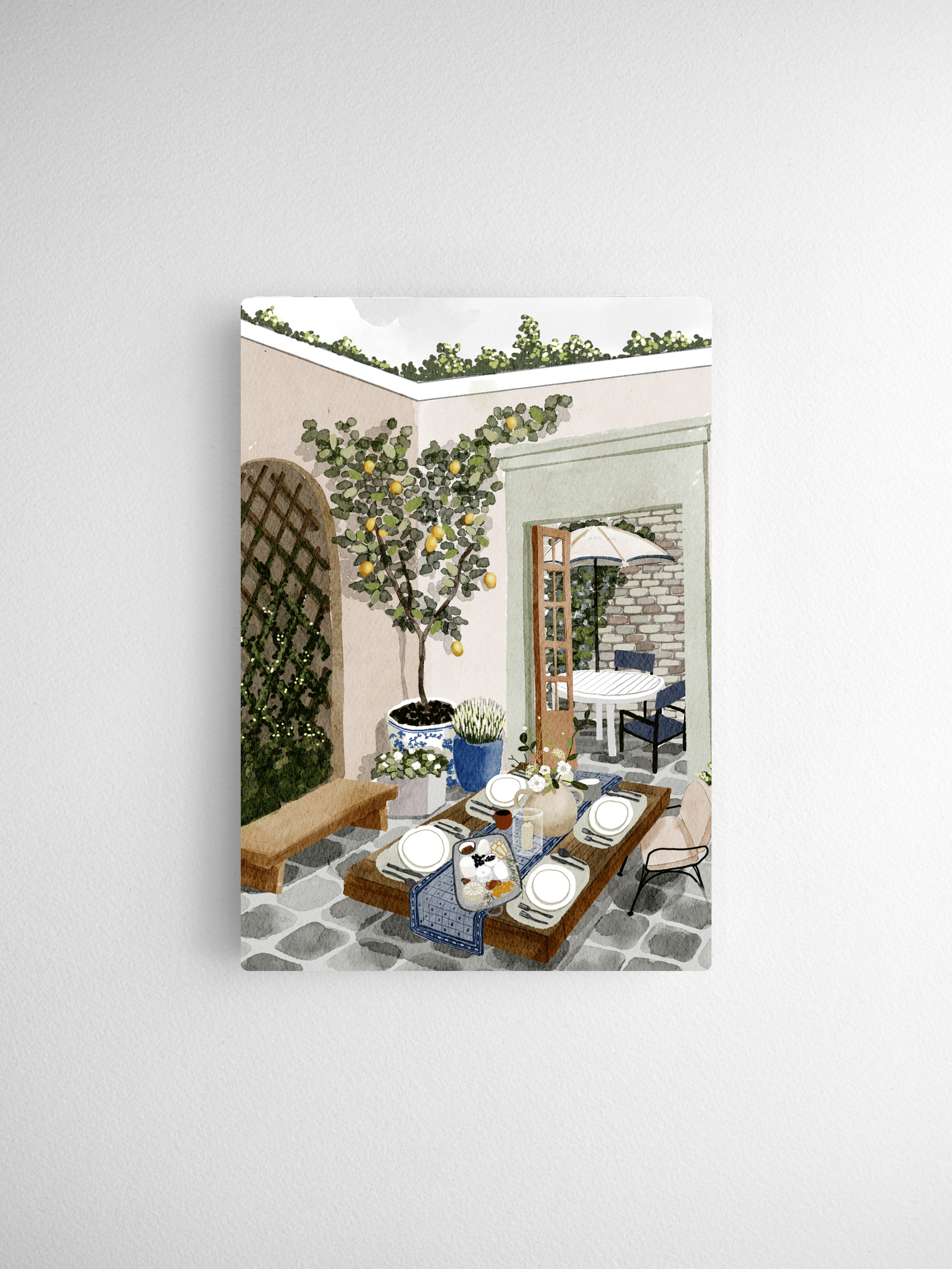 Detailed watercolor illustration of a sunny Mediterranean cafe patio, featuring a lemon tree, a rustic table set with dishes, and yellow citrus accents.