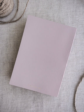 Dusty rose minimalist notebook featuring a smooth, matte cover, perfect for organized travel journaling and daily planning.