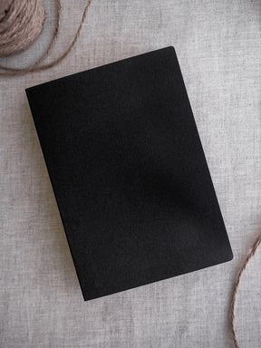 A solid, minimalist black B6 grid notebook featuring a smooth, plain cover for journaling, study, or general note-taking.