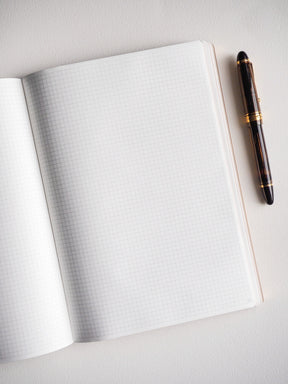 Open B5 notebook featuring 272 pages of precise graph-ruled grid paper, offering a highly structured surface perfect for detailed note-taking, charting, or study planning.