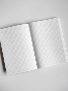Open A5 undated planner showing two pages covered in faint light gray graph paper, ideal for organized daily note-taking and planning.