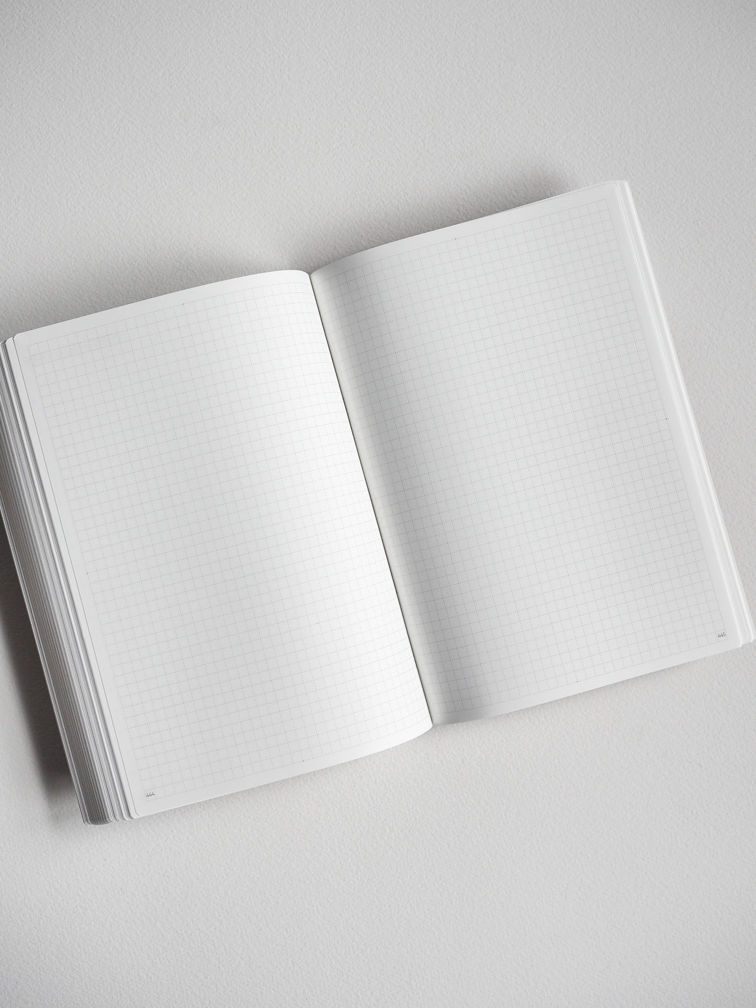 Open B6 undated daily planner featuring crisp, light-grid graph paper pages for flexible year-long planning and journaling.