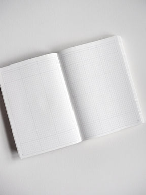 Open B6 undated planner displaying fine, light-gray grid lines across two pages, perfect for daily journaling, scheduling, or tracking.