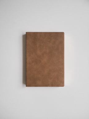 A handsome, textured cognac brown B6 undated planner, designed for comprehensive daily journaling and yearly scheduling.
