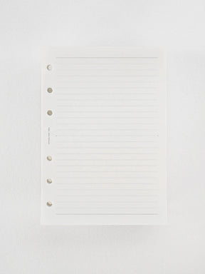 A stack of premium Tomoe River brand loose leaf paper, featuring white sheets precisely ruled with 5mm horizontal blue lines for writing and journaling.