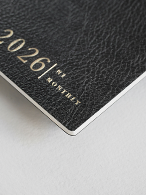 Dark, textured N1 monthly booklet cover with elegant embossed branding reading "2026," perfect for a yearly planner or journal.