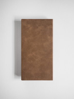 Minimalist grid notebook bound in rich, solid brown faux leather, featuring a smooth, subtly textured cover suitable for everyday writing.