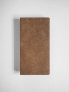 Minimalist grid notebook with a solid, textured, tan faux-leather cover, designed for writing and planning.