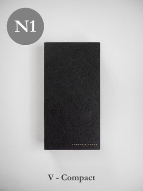 Elegant black planner journal featuring a textured, faux-leather finish and the subtle branding "Common Planner" near the base.